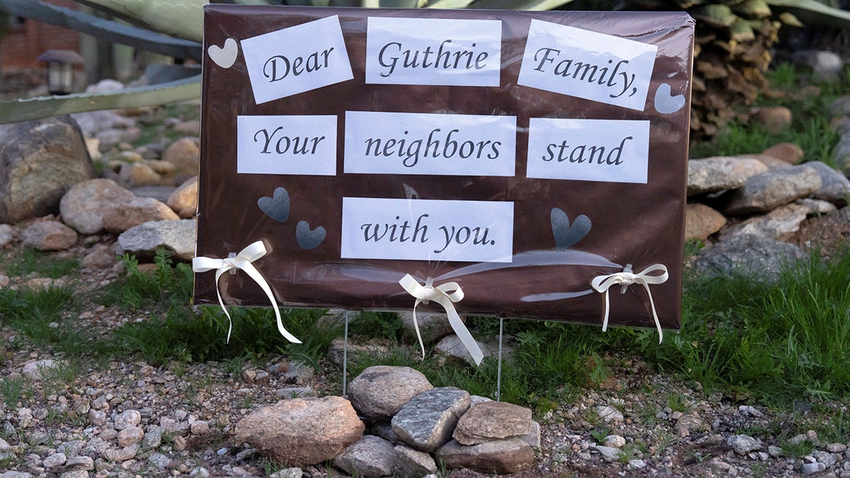 A supportive handwritten sign posted outside Nancy Guthrie's home in Tucson