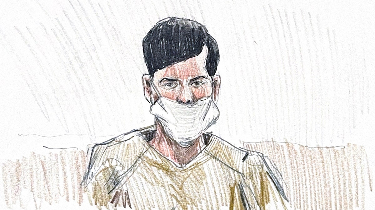 Jose Medina-Medina sitting at a table during a court hearing while a legal professional speaks.