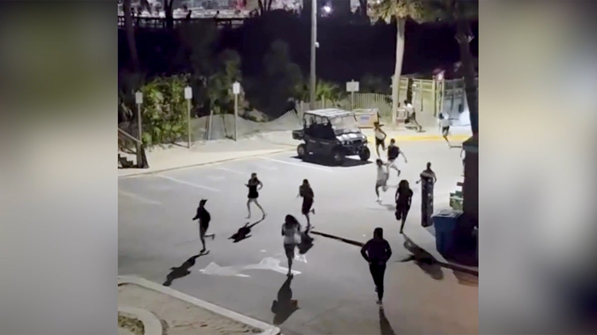 A large crowd dispersing on Tybee Island pier after gunfire incident
