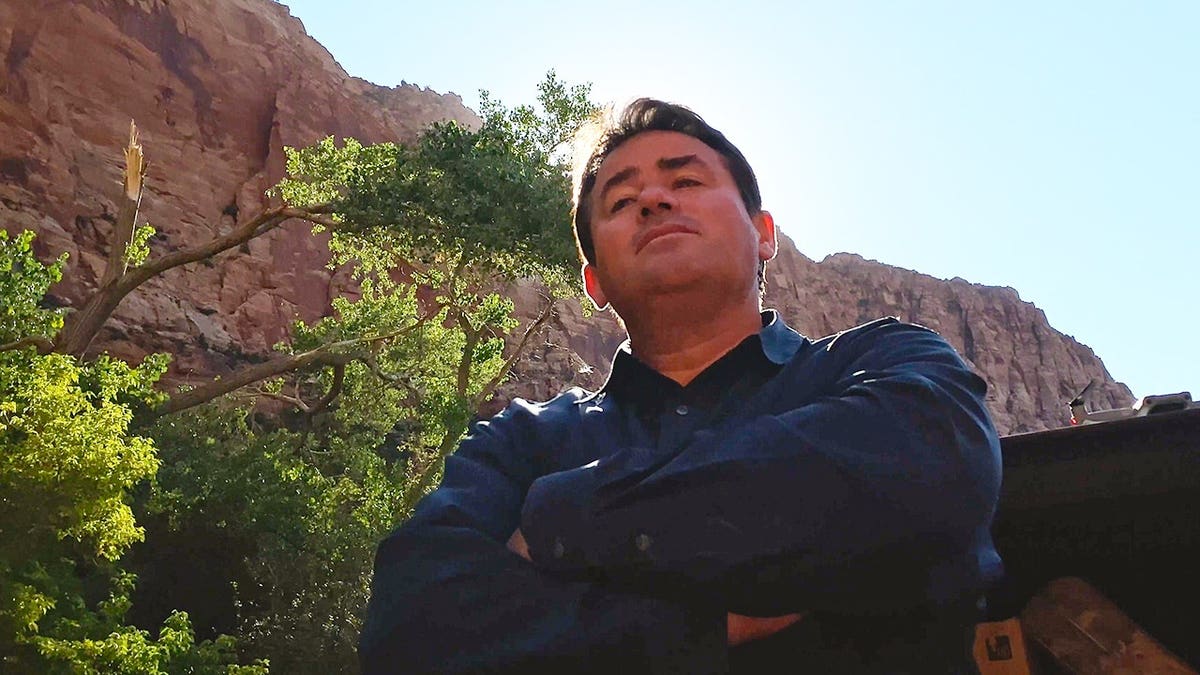 Samuel Bateman standing in a scene from Trust Me: The False Prophet Season 1