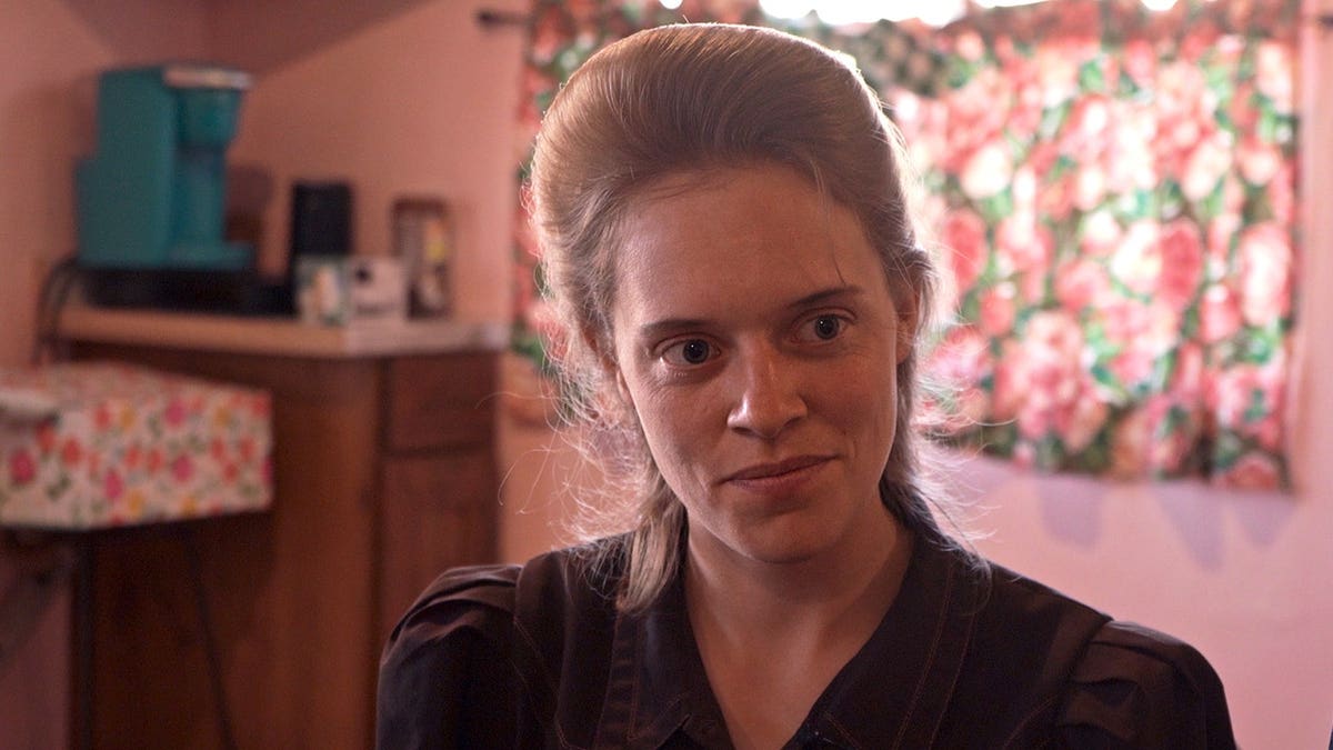 Naomi Nomz standing in a scene from Trust Me The False Prophet Season 1