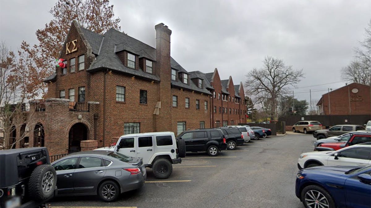Crew Kvern standing outside the University of Arkansas Kappa Sigma fraternity house