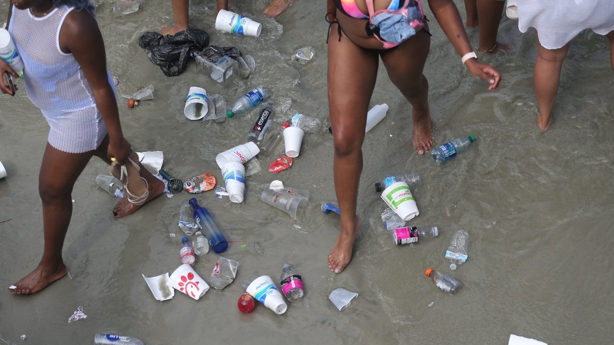 Trash floating in water at Tybee Island beach during Orange Crush event