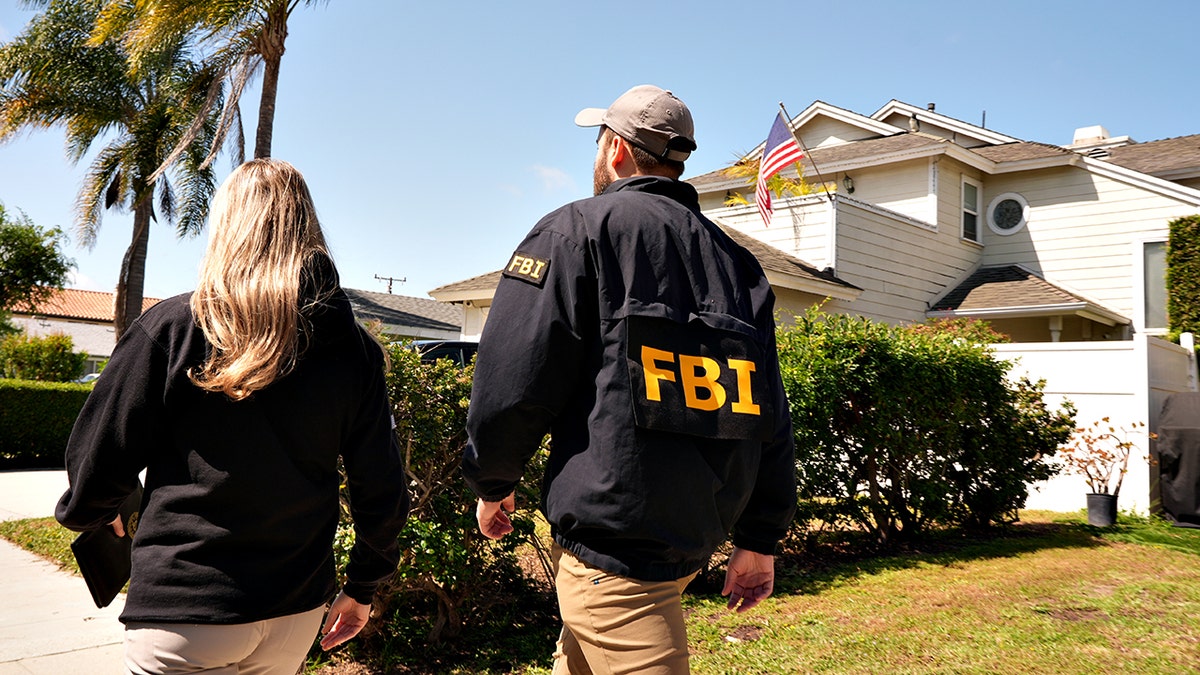 FBI agents walking door to door in a residential neighborhood in Torrance, Calif.