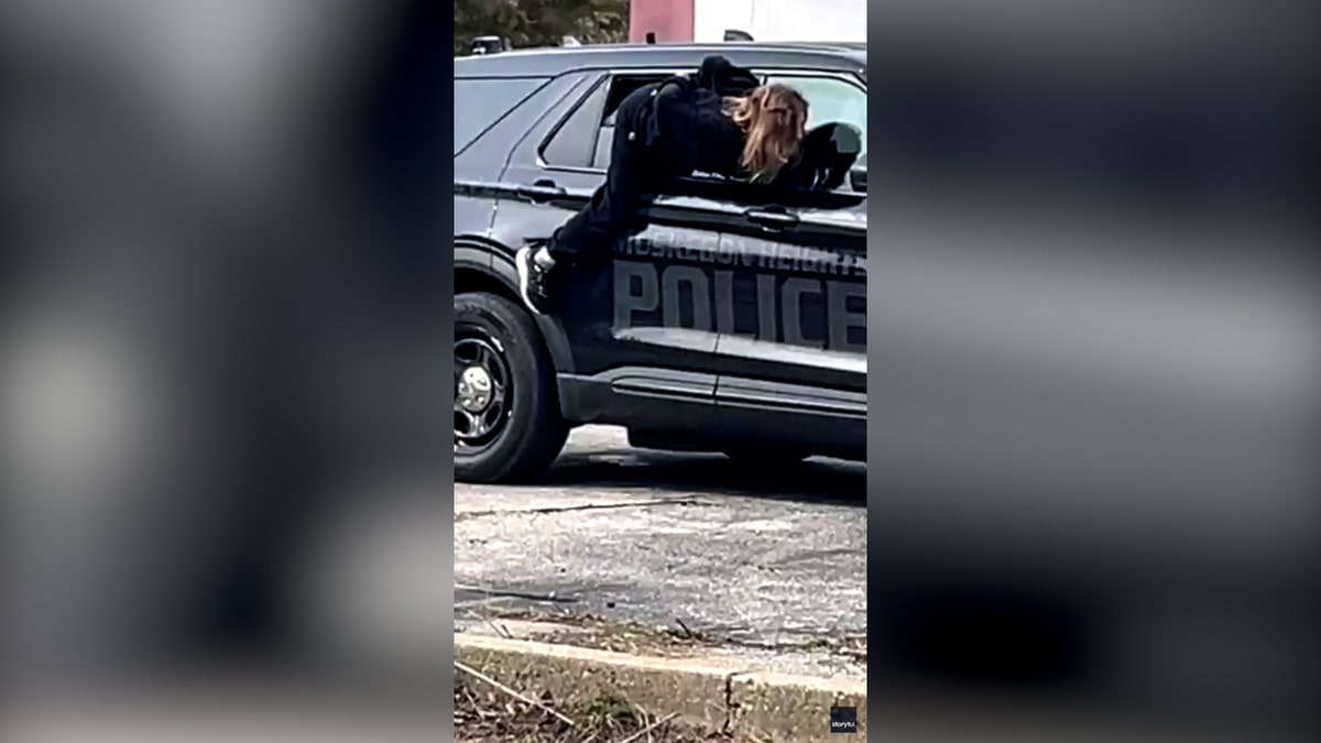 handcuffed woman wriggles out of car window