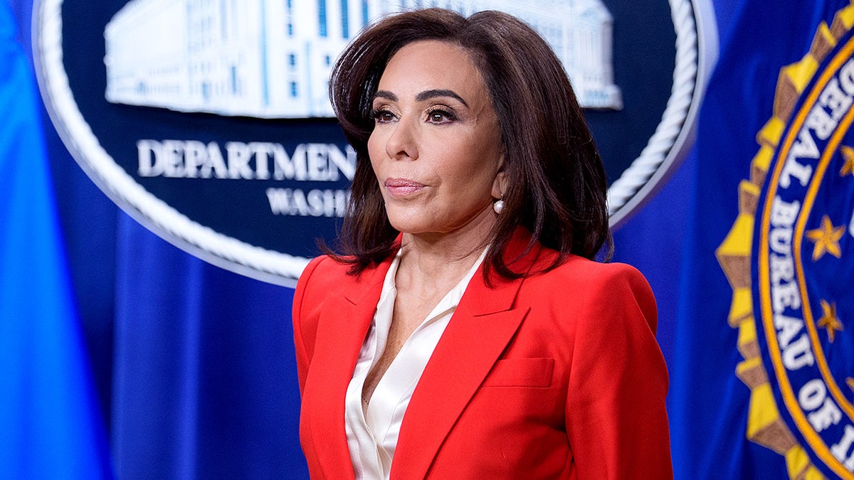 Jeanine Pirro speaking at a news conference at the Department of Justice