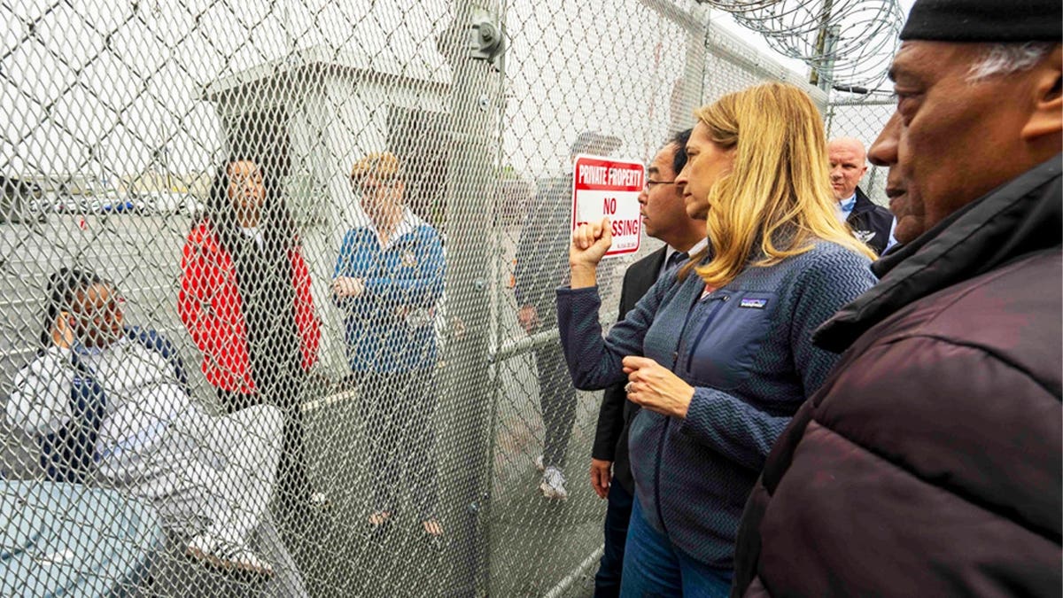 New Jersey Governor Mikie Sherrill and Sen. Andy Kim, D-N.J., stand outside Newark, New Jersey's Delaney Hall detention center during a protest.