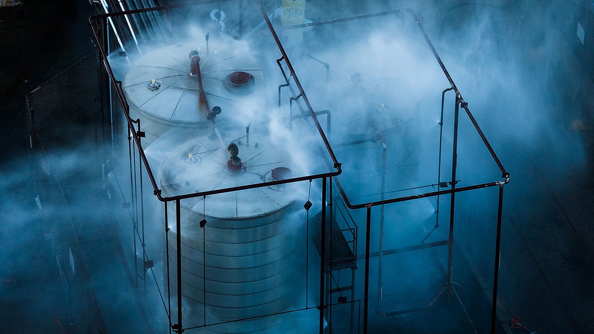 Water spraying on an overheated tank at an aerospace plant in Garden Grove, Calif.
