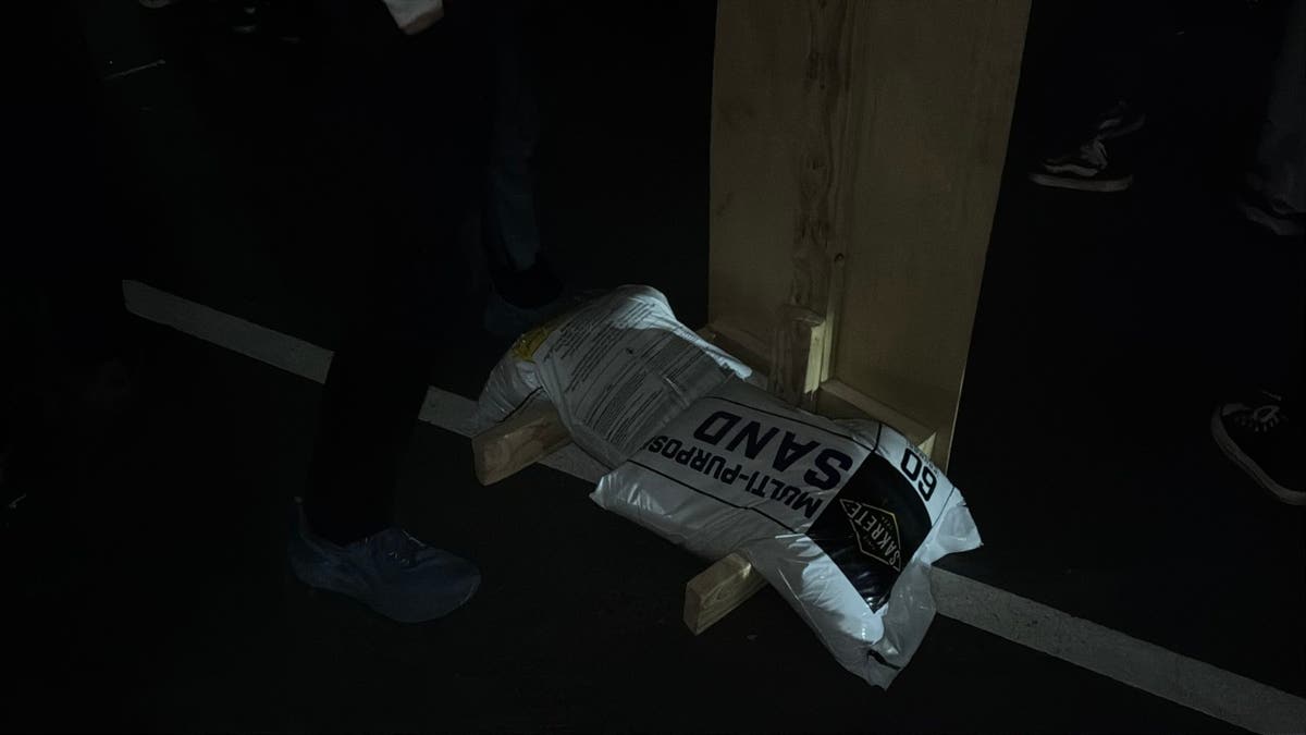 A sandbag being used to reinforce a barricade