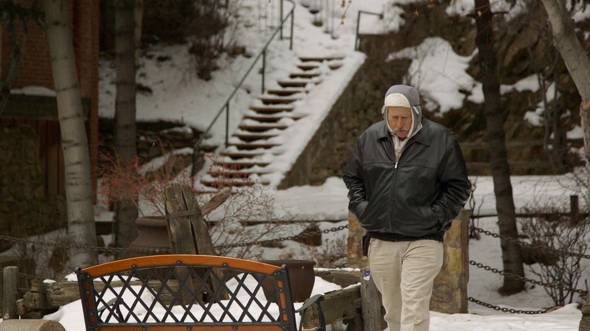 Benjaman Kyle walking through a snowy park in Colorado