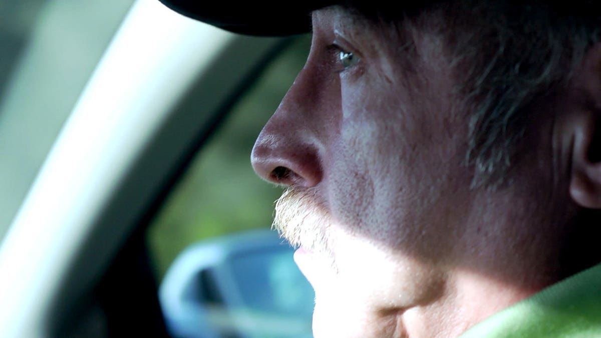 Benjaman Kyle sitting in the passenger seat of a car in profile.