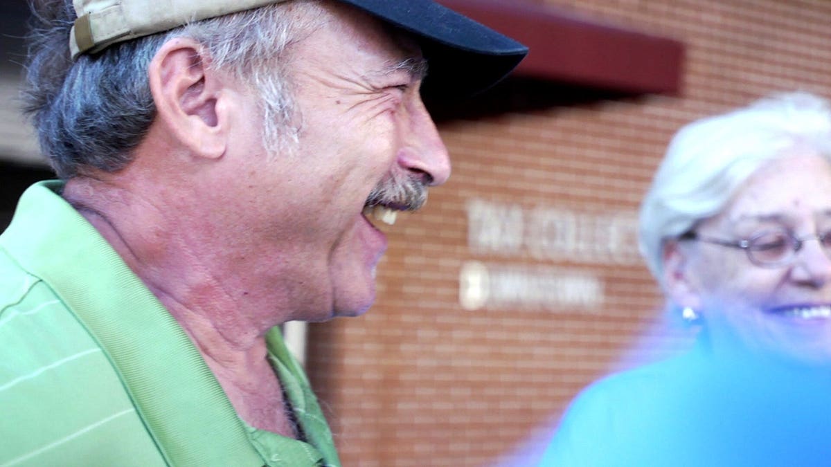 Benjaman Kyle laughing with an older woman.
