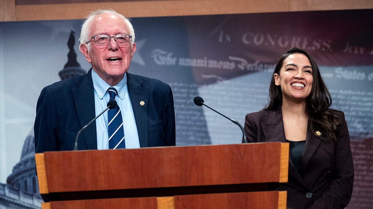 Sen. Bernie Sanders and Rep. Alexandria Ocasio-Cortez speaking at a news conference in the U.S. Capitol