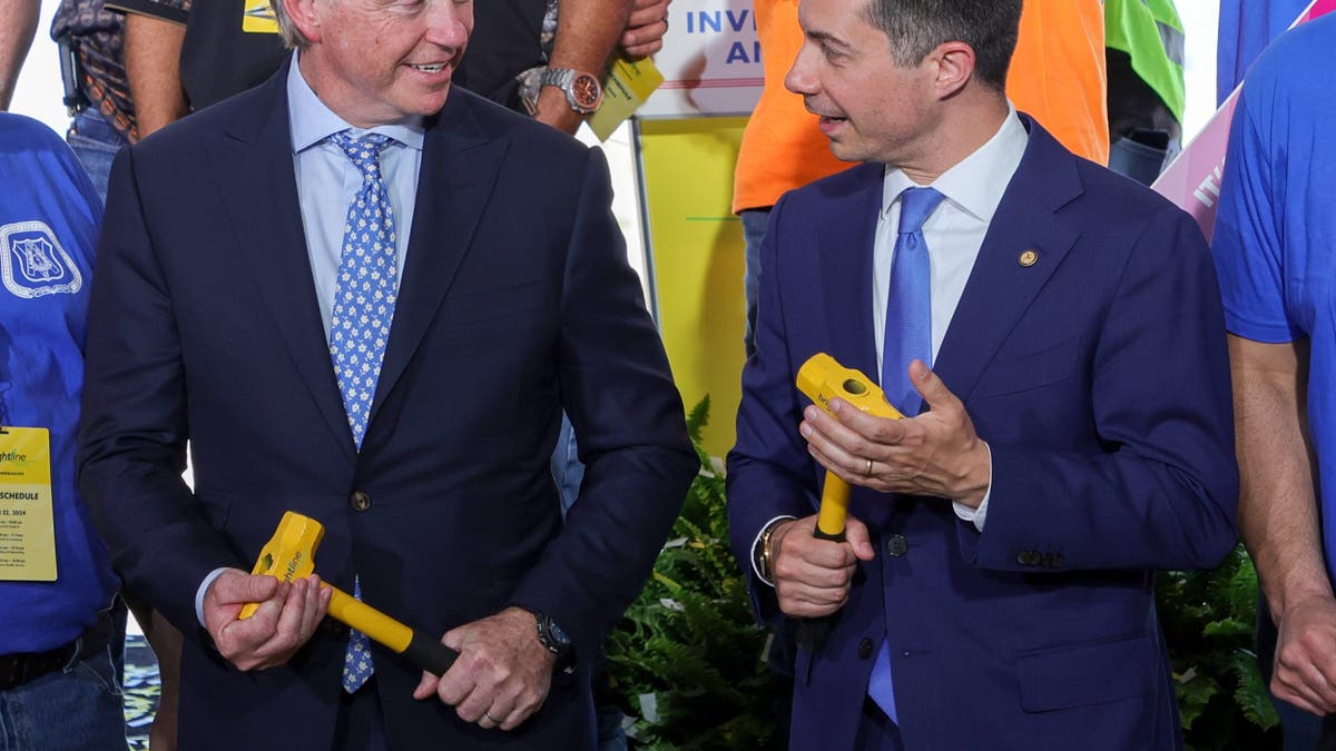 Brightline founder Wes Edens and Transportation Secretary Pete Buttigieg talking at groundbreaking ceremony in Las Vegas