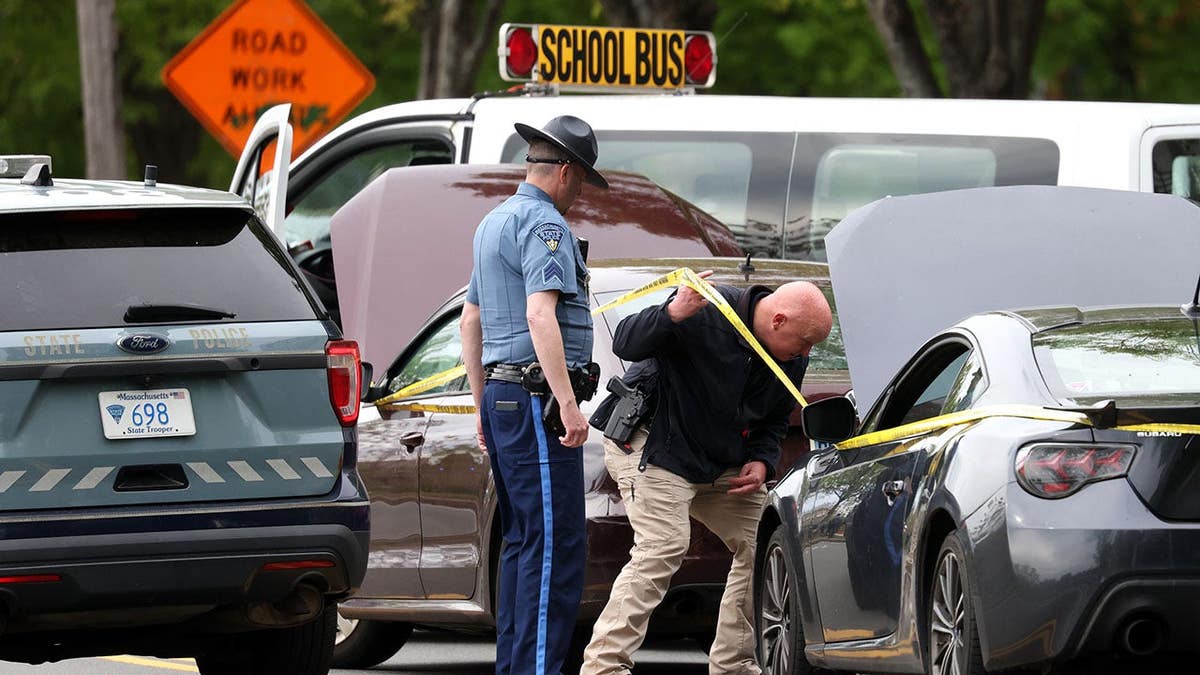 Police officers investigating shooting scene on Memorial Drive in Cambridge