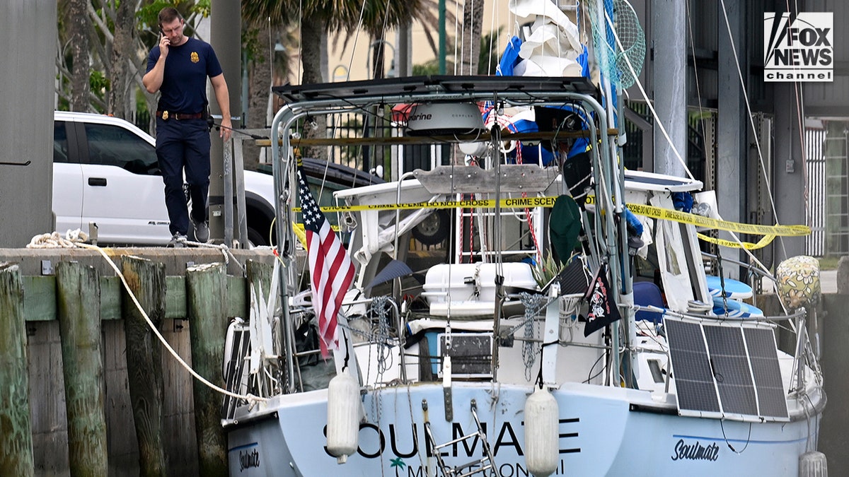 U.S. Coast Guard investigators searching the boat Soulmate docked at a station in Fort Pierce, Florida