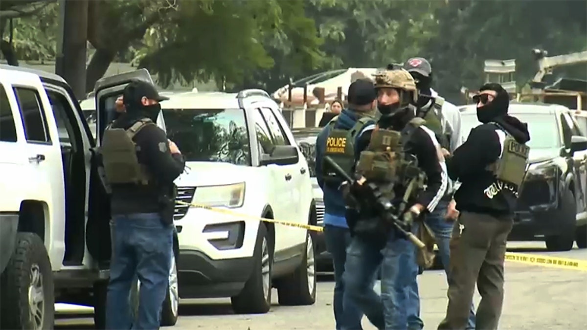 DHS officers walking near cars in a parking lot in Compton, California