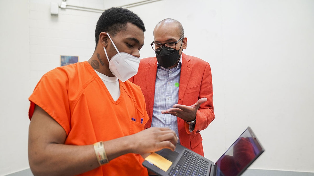 Antonio Hawley talks to Magistrate Judge Zia M. Faruqui on a basketball court at DC Central Detention Facility