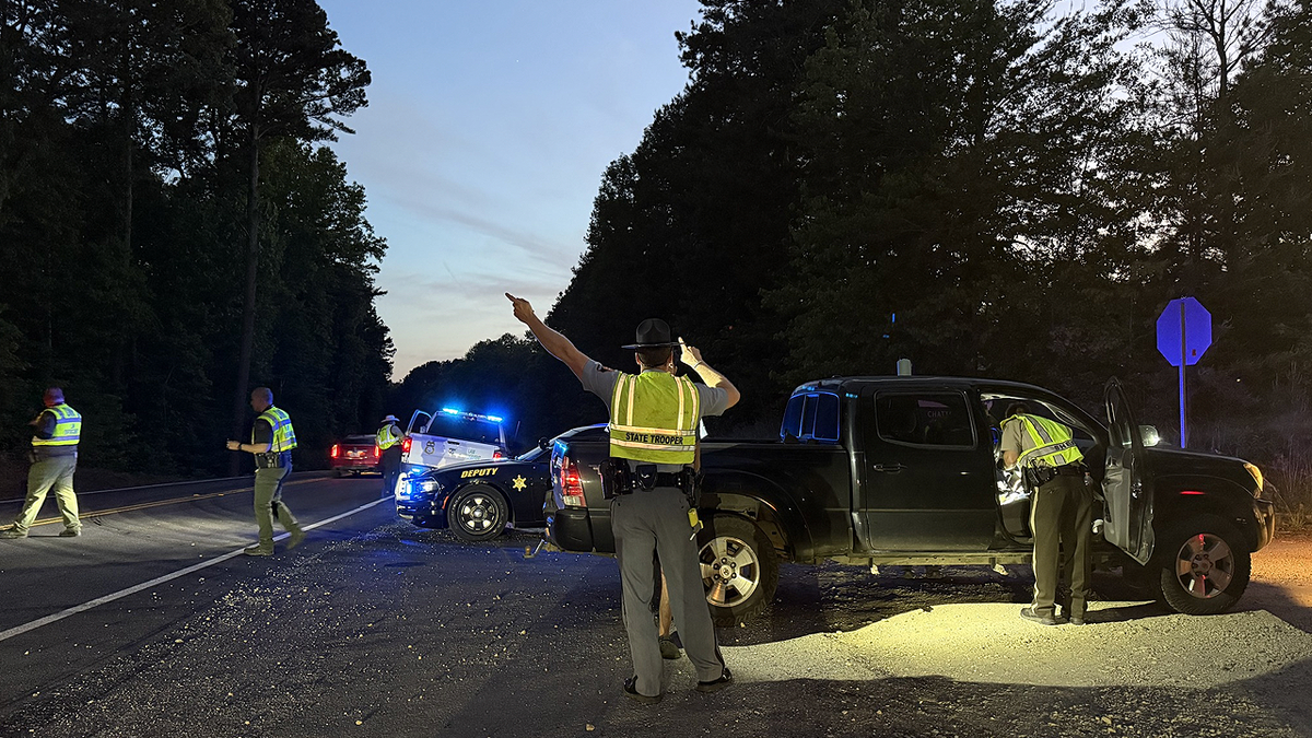 Georgia State Patrol troopers direct traffic during a nighttime enforcement operation tied to Operation Southern Forest Trident