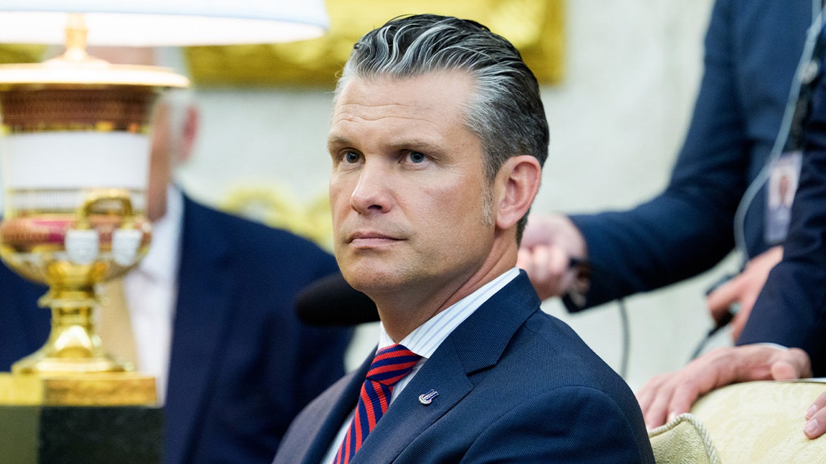 Pete Hegseth seated in the Oval Office during a meeting