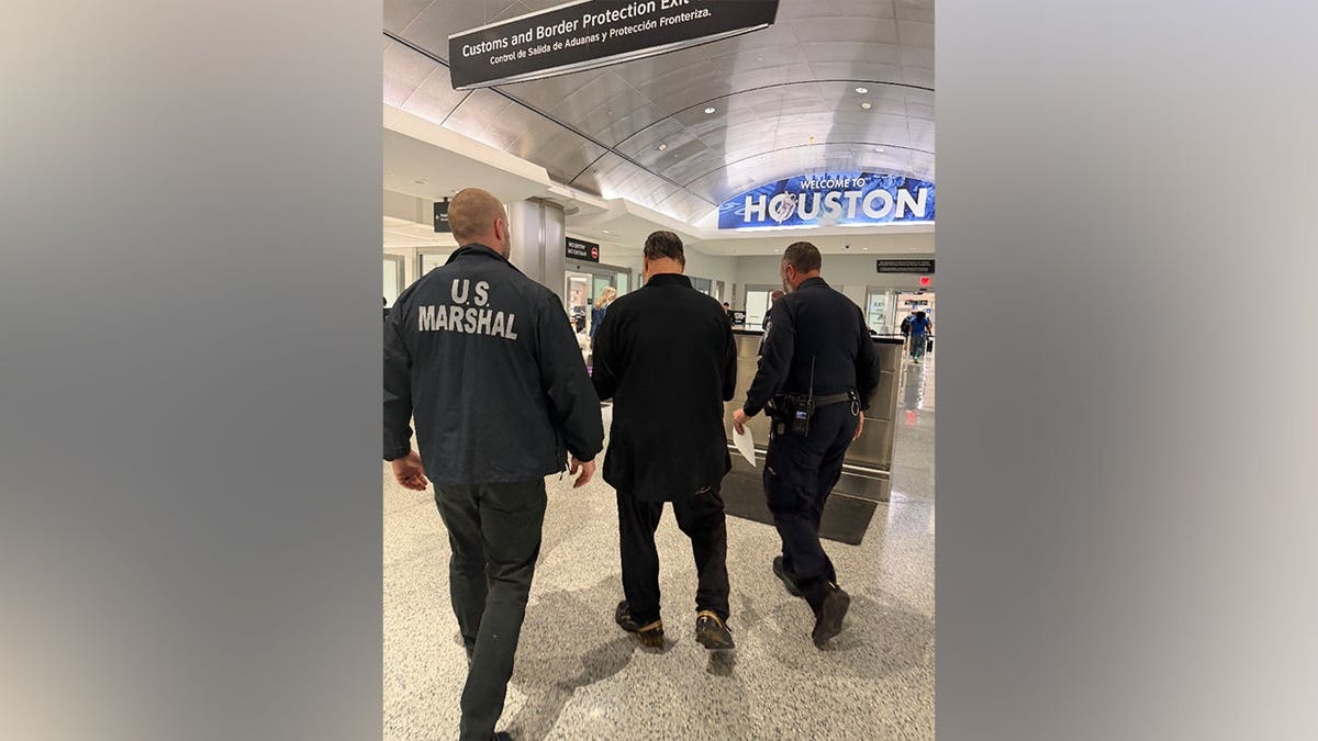 Richard Werstine standing in handcuffs during arrest in Panama City