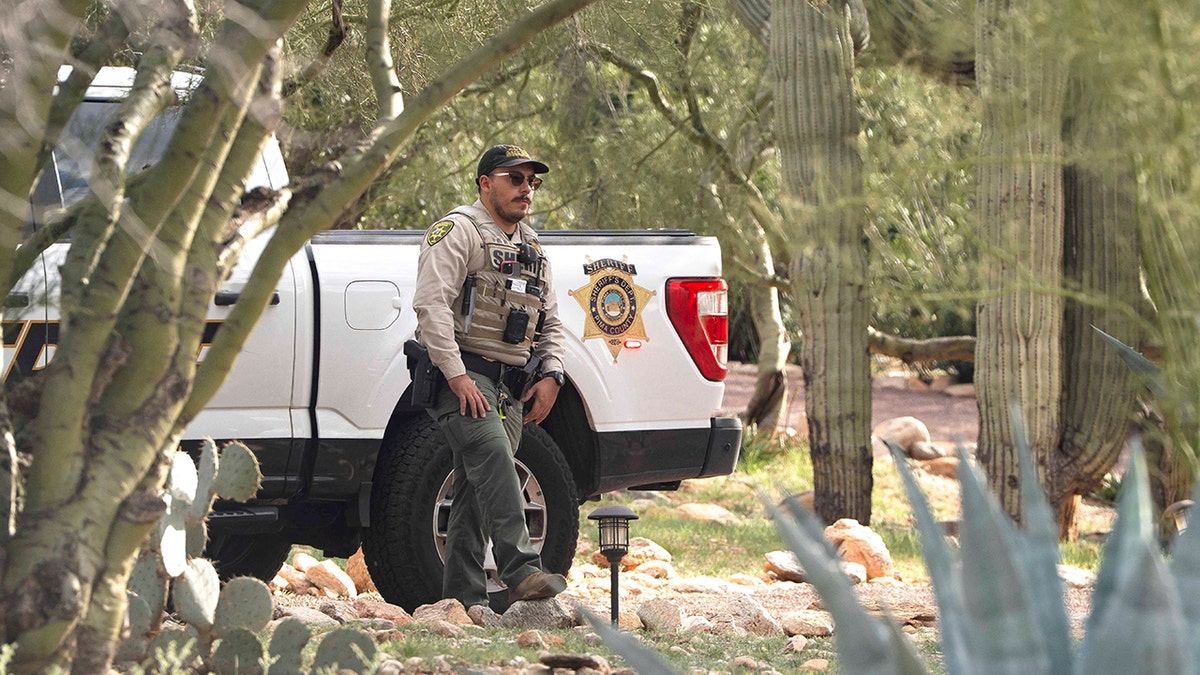 Pima County Sheriff’s Department deputy standing guard outside Nancy Guthrie's home in Tucson, Arizona