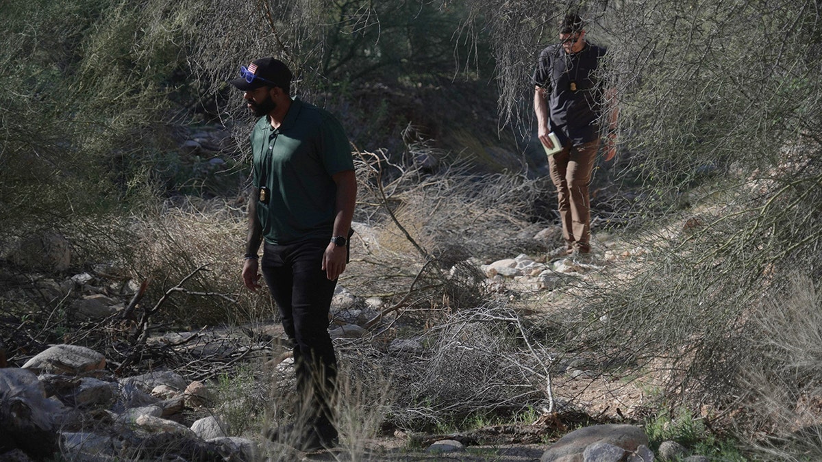 Law enforcement agents searching vegetation near Nancy Guthrie's home in Tucson