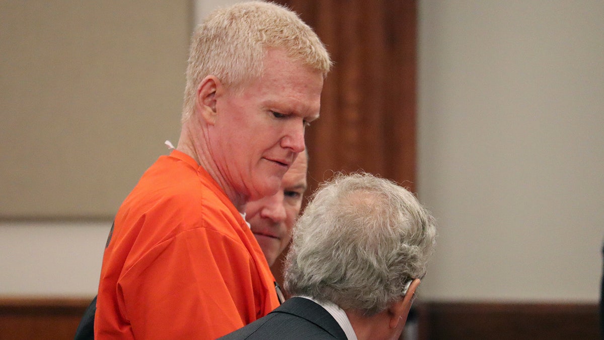 Alex Murdaugh wearing an orange jumpsuit in a courtroom