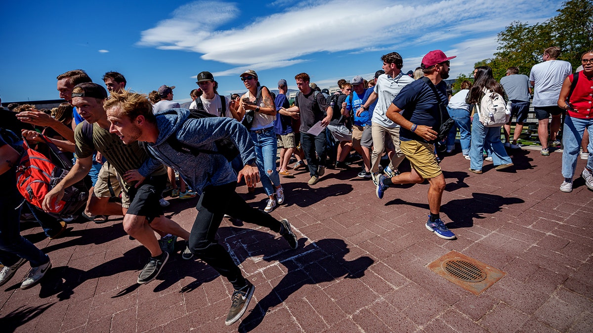 Charlie Kirk speaking at Utah Valley University event as people run after shots fired
