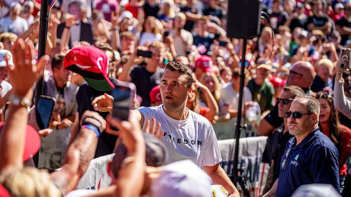 Charlie Kirk tossing hats to a crowd at Utah Valley University rally