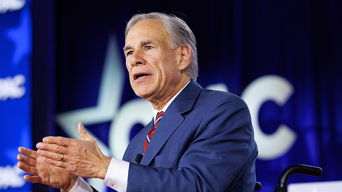 Greg Abbott speaking at a lectern during CPAC in Grapevine, Texas.