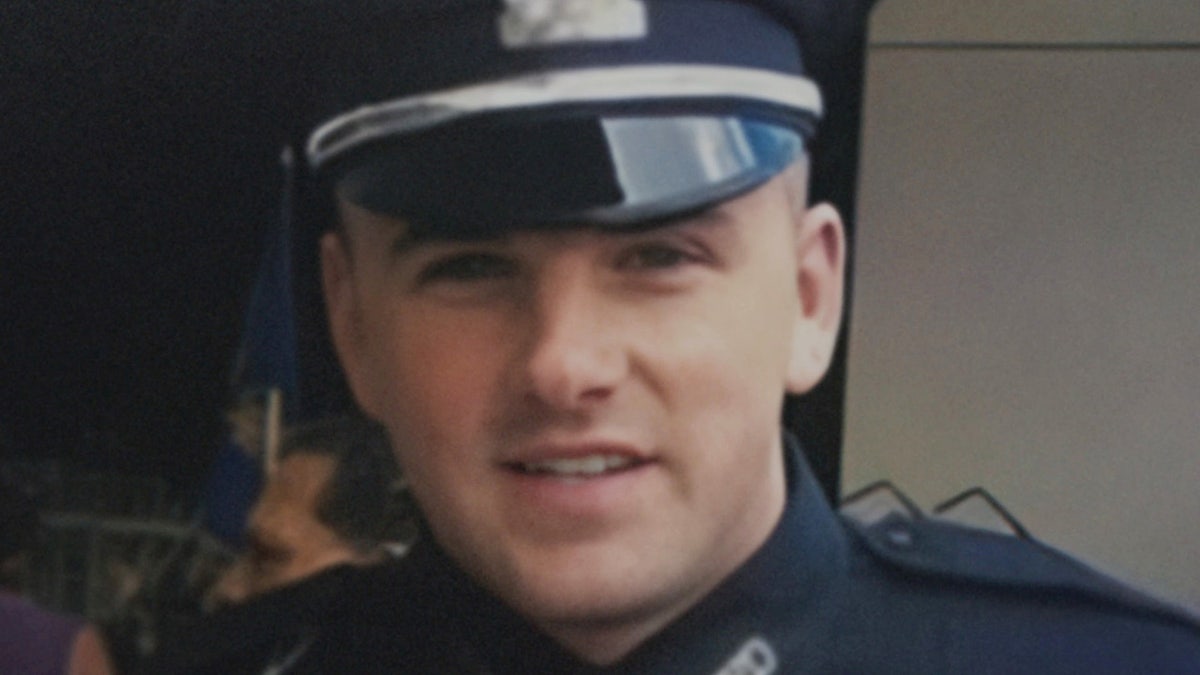 John O'Keefe wearing Boston police uniform looking at camera