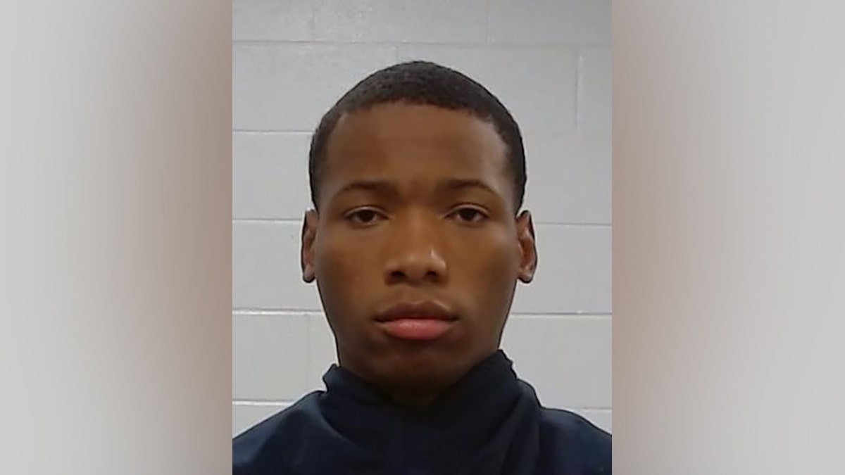 Karmelo Anthony standing for a mugshot photo.