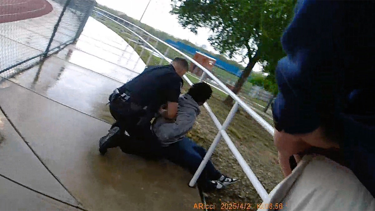 Karmelo Anthony being placed in handcuffs by law enforcement officers.