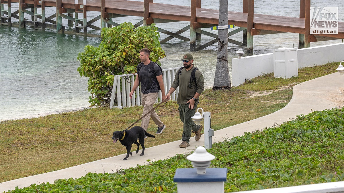 Members of Broward County Sheriff's Office and Maggie the cadaver dog arrive at Abaco Inn in Hope Town