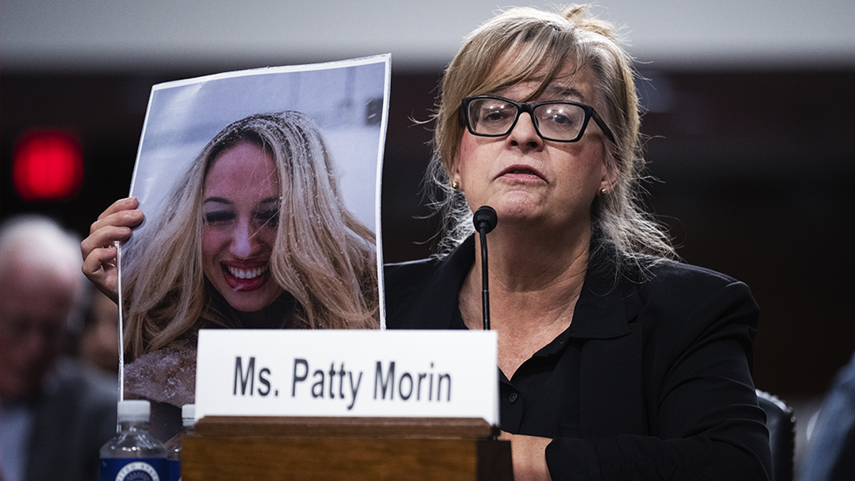 Patty Morin holding a photo of her daughter Rachel during a Senate Judiciary Committee hearing