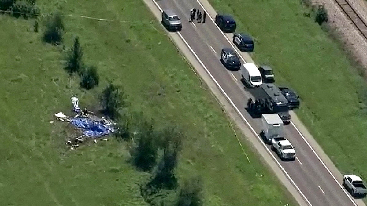 Aerial view of a plane crash site in Missouri with emergency responders present