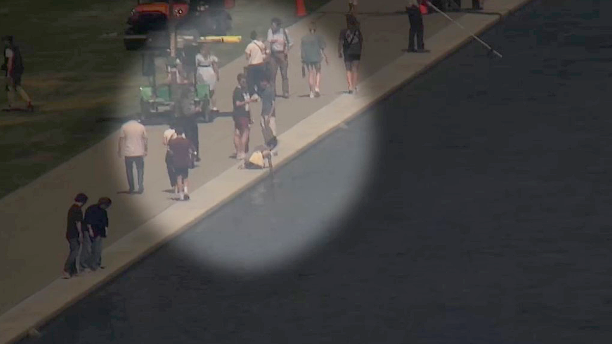 A woman depicted at the Reflecting Pool