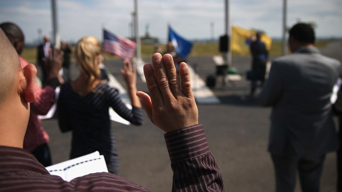 man raises hand during ceremony