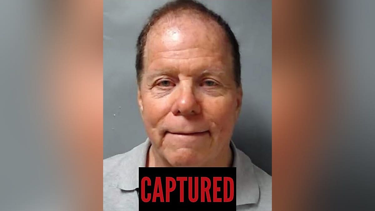 A recent booking-style photo of Ronald L. Fischer with a black 
