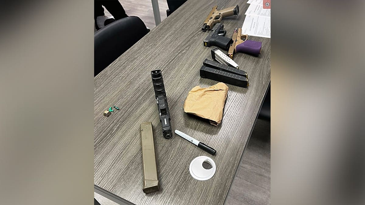 A makeshift spear with a knife blade attached to a wooden handle lies on the ground after being recovered by North Charleston Police.