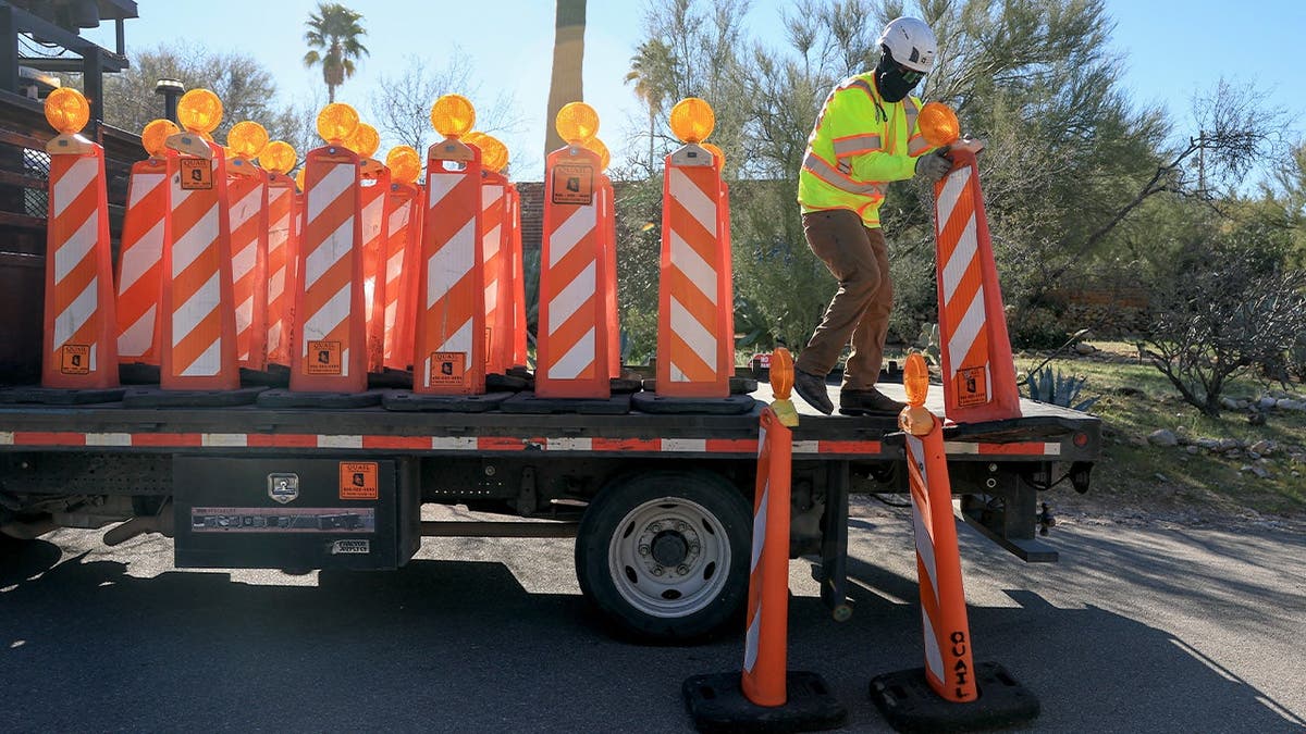 Workers remove barriers in front of Nancy Guthrie's home