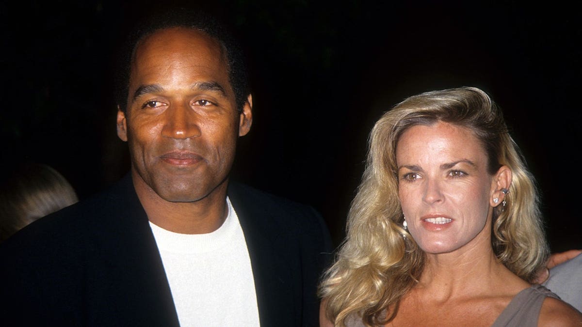 O.J. Simpson and Nicole Brown Simpson pose at a premiere.