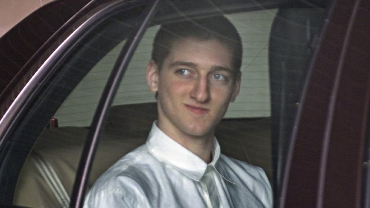 Robert Tulloch in the back of a police car following his arrest.