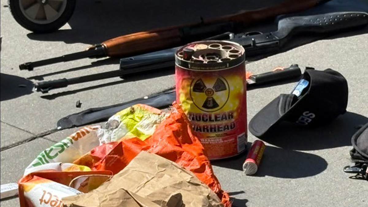 Weapons, including hatchets, BB guns and knives were seized from a cart with an anti-ICE banner on it
