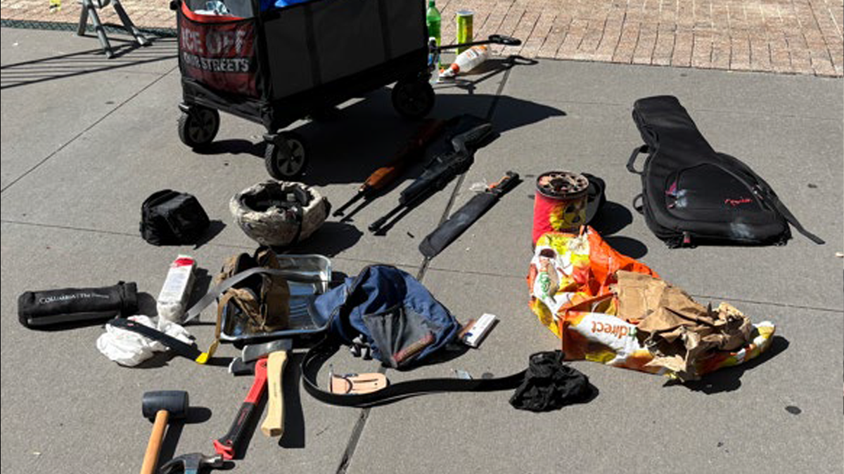 Weapons, including hatchets, BB guns and knives were seized from a cart with an anti-ICE banner on it