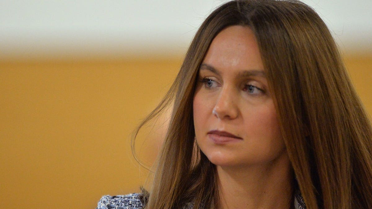 Ashley Benefield stands in a courtroom during a legal hearing.
