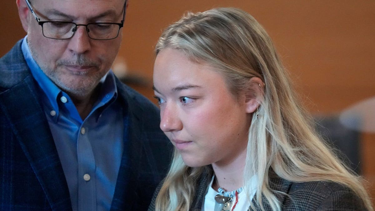 Eva Benefield, daughter of Doug Benefield, returns to her seat in a courtroom after presenting her victim impact statement.
