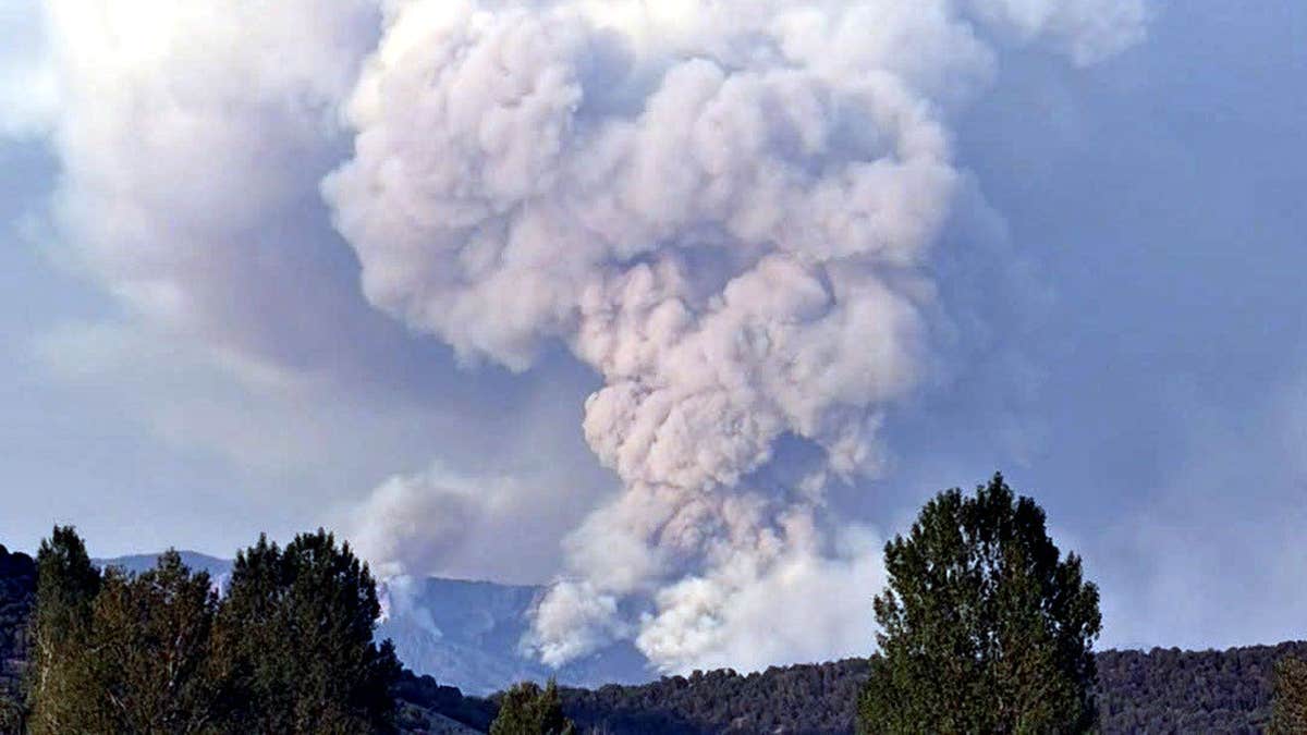 smoke billowing over mountains