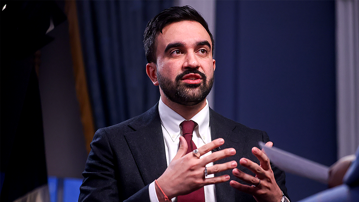 Zohran Mamdani speaking with hands at chest level